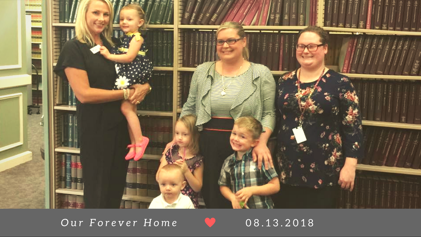 Adoptive family with their CASA volunteer and caseworker on adoption day. 